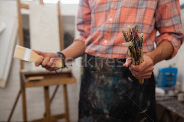 Stock photo: Man selecting a paintbrush