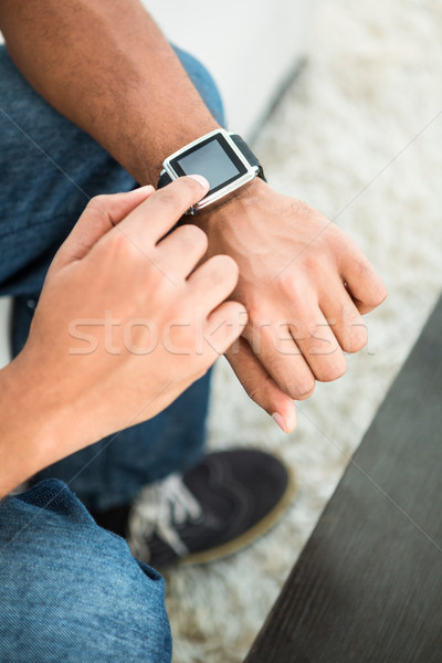 Stock photo: High angle view of man using smart watch