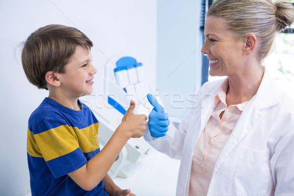 Happy dentist playing with boy Stock photo © wavebreak_media