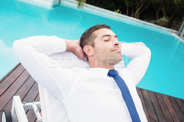 Smarty dressed man relaxing on sun lounger Stock photo © wavebreak_media