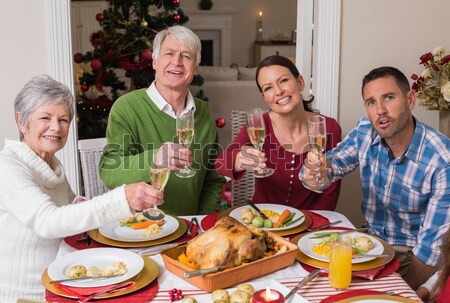 Stock photo: Happy friends playing cards while having beer and snacks