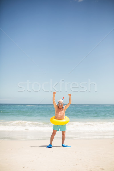 Senior man with swimming ring and flippers at the beach Stock photo © wavebreak_media