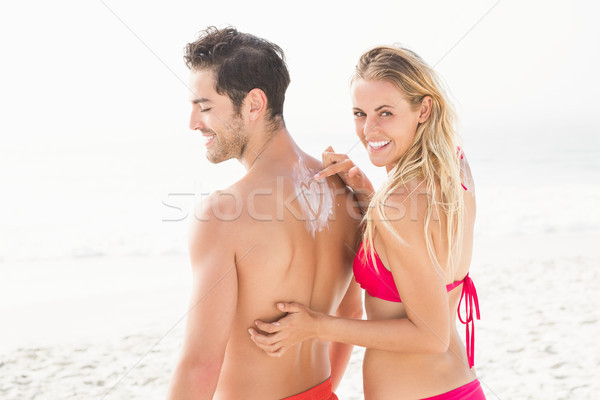 Girlfriend applying sun cream on boyfriend Stock photo © wavebreak_media