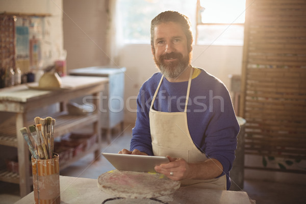 Portrait of male potter using digital tablet Stock photo © wavebreak_media