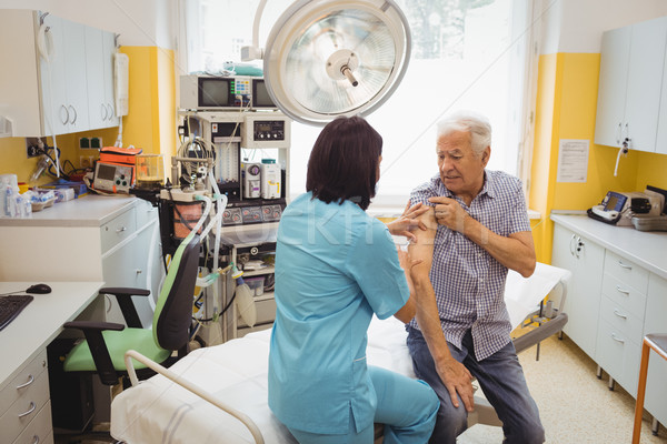 Female doctor giving an injection to a patient Stock photo © wavebreak_media