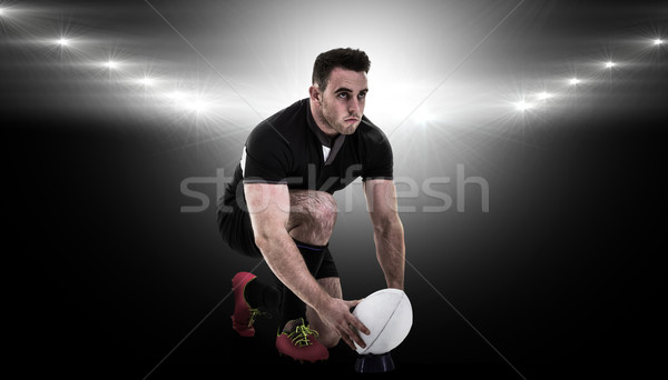Stock photo: Composite image of rugby player getting ready to kick ball