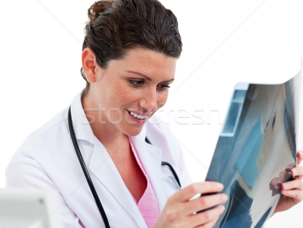 Smiling female doctor looking at X-ray in his office Stock photo © wavebreak_media