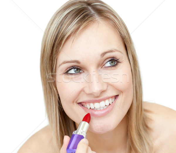 Stock photo: Portrait of a charismatic woman putting red lipstick