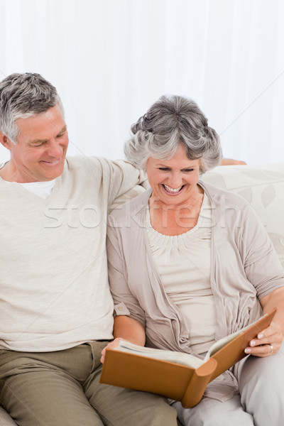 Senior couple looking at their photo album at home Stock photo © wavebreak_media
