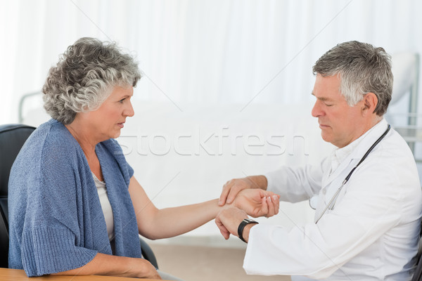 A senior doctor doing an examination of his patient in his office Stock photo © wavebreak_media