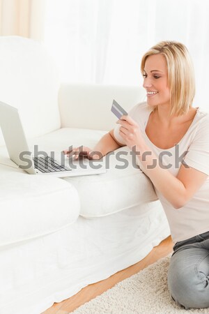 Cute woman booking her holidays online in her living room Stock photo © wavebreak_media