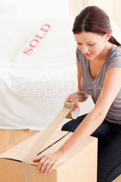 A woman preparing a cardboard for the transport Stock photo © wavebreak_media