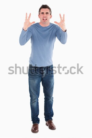 Angry man rising his hands against a white background Stock photo © wavebreak_media