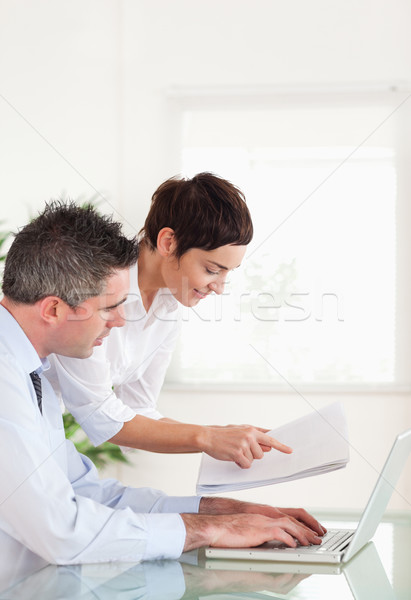 Portrait of colleagues comparing a blueprint folder to an electronic one in an office Stock photo © wavebreak_media