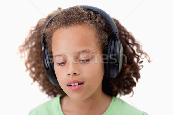 Young girl listening to music against a white background Stock photo © wavebreak_media