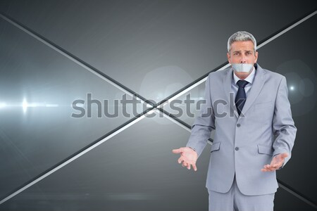 Stock photo: Portrait of a handsome office worker putting his tie against a white background