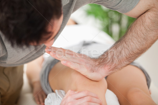 Serious practitioner pushing on the knee of a patient in a room Stock photo © wavebreak_media
