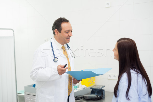 Doctor and patient talking together in an examination room Stock photo © wavebreak_media