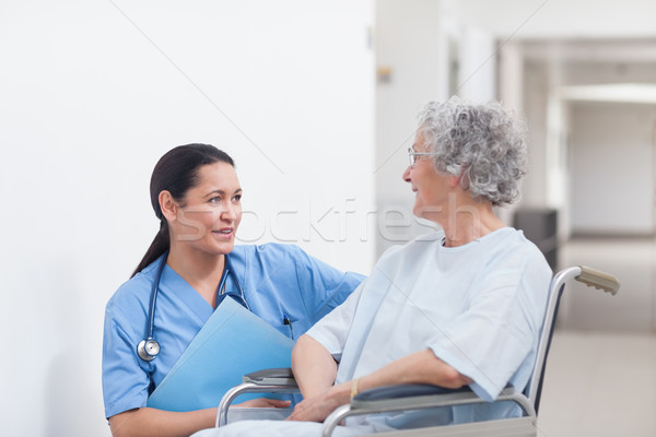 Nurse next to a patient in a wheelchair in hospital ward Stock photo © wavebreak_media