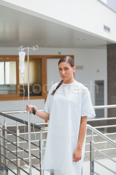 Female patient holding a drip stand in hospital ward Stock photo © wavebreak_media