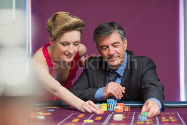 Man and woman placing bets at roulette table Stock photo © wavebreak_media