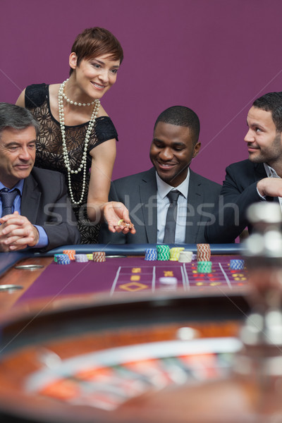 Woman placing bet at roulette table in casino Stock photo © wavebreak_media