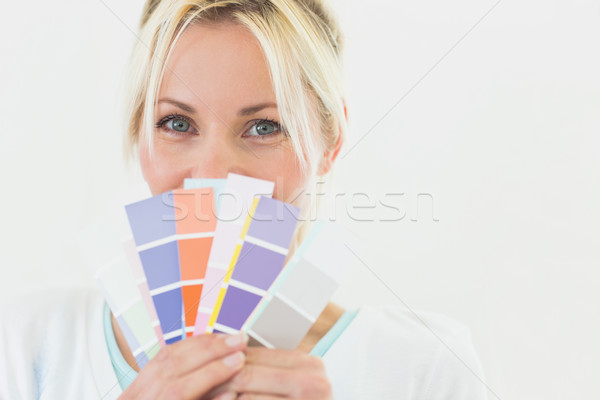 Closeup portrait of a beautiful woman holding color swatches Stock photo © wavebreak_media