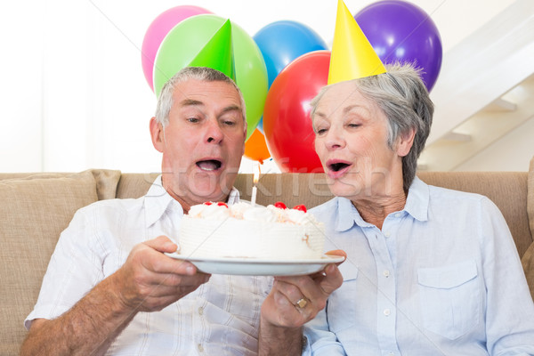 Couple de personnes âgées séance canapé célébrer anniversaire maison [[stock_photo]] © wavebreak_media