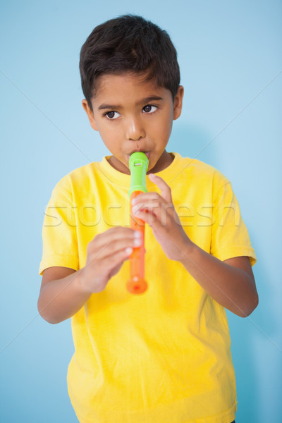 Cute little boy playing the recorder in classroom Stock photo © wavebreak_media