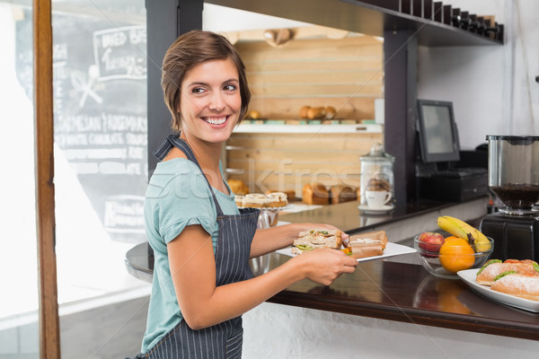 Stock photo: Pretty waitress holding plate of food