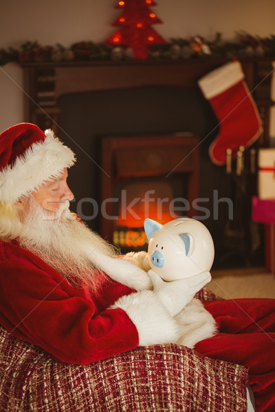 Papá noel alcancía Navidad casa salón Foto stock © wavebreak_media