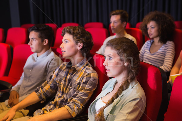 Stock photo: Young friends watching a film
