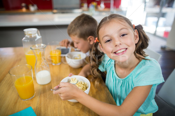 Smiling sibling having breakfast cereal in kitchen Stock photo © wavebreak_media
