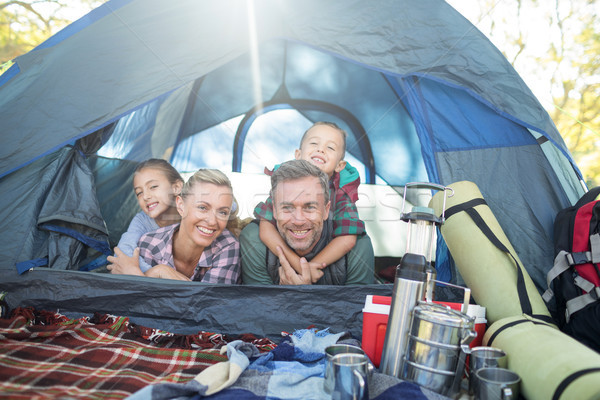 Stock photo: Smiling family lying in the tent