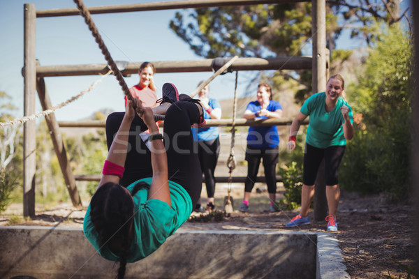 Fit woman climbing a rope during obstacle course training Stock photo © wavebreak_media