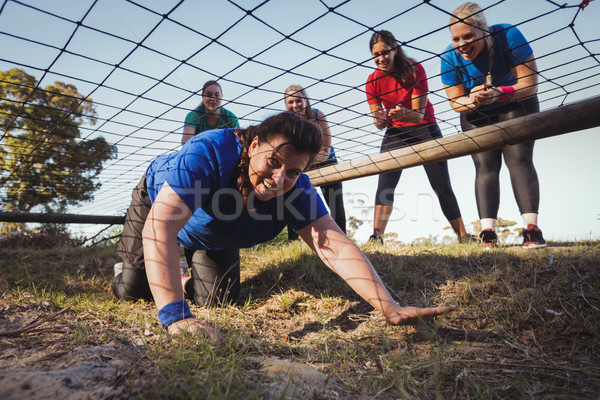 Woman being cheered bye her teammates during obstacle course training Stock photo © wavebreak_media