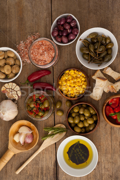 Olives with spice and corns with oil in bowl on table Stock photo © wavebreak_media