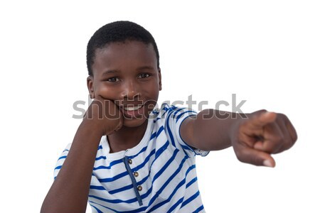 Happy boy pointing his finger against white background Stock photo © wavebreak_media