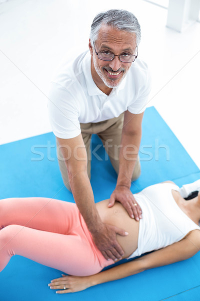 Doctor giving physiotherapy to pregnant woman Stock photo © wavebreak_media