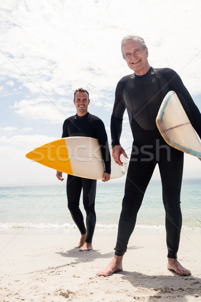 Retrato feliz filho pai em pé prancha de surfe praia Foto stock © wavebreak_media