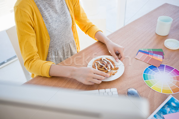 Woman eating breakfast at work Stock photo © wavebreak_media