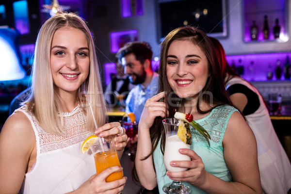 Smiling friends having cocktail at bar counter Stock photo © wavebreak_media