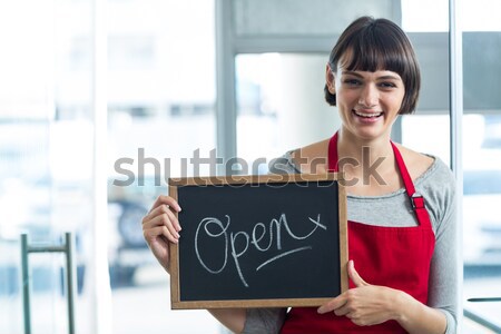 Stock photo: Smiling waitress showing slate with open sign