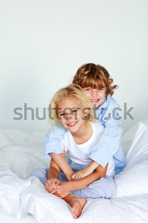Brother embracing her sister in bed Stock photo © wavebreak_media