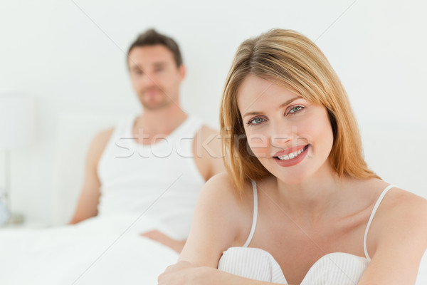 Superb woman looking at the camera with her husband at home Stock photo © wavebreak_media