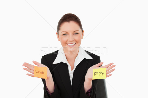 Smiling businesswoman torn between work and play against a white background Stock photo © wavebreak_media