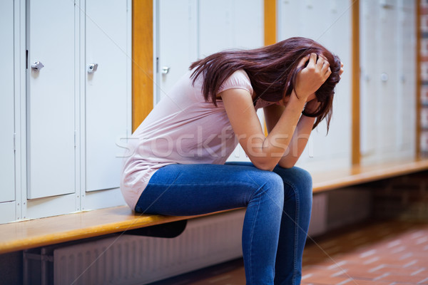 Sad student sitting on a bench in a corridor Stock photo © wavebreak_media