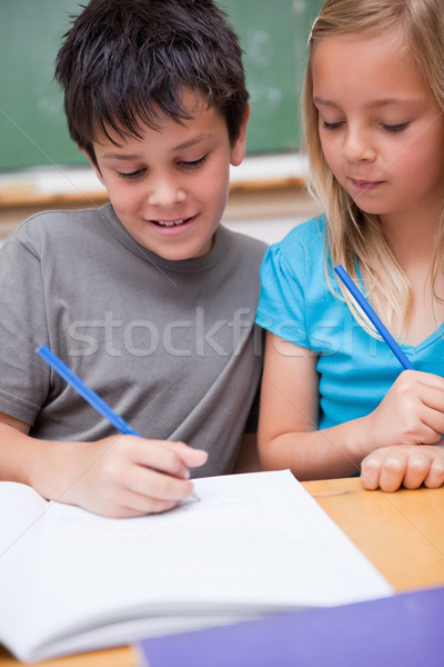 Portrait of smiling pupils working together in a classroom Stock photo © wavebreak_media