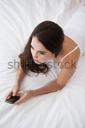 Shot kobieta bed smartphone ręce Zdjęcia stock © wavebreak_media