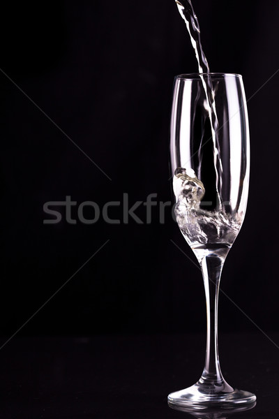 Empty champagne flute being filled against black background Stock photo © wavebreak_media